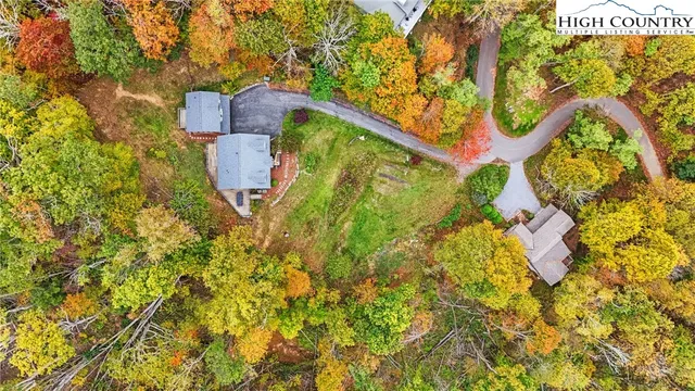 a living room with furniture a fireplace and a large window