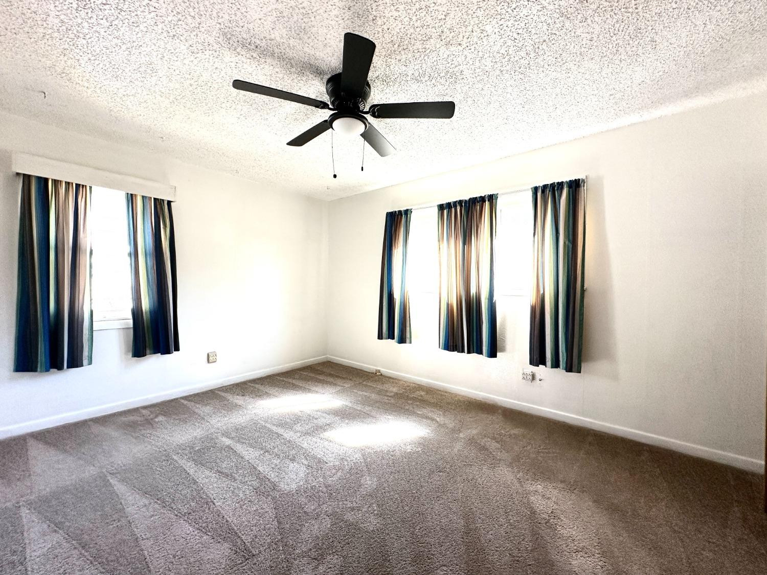 3004 43rd Street Lubbock, TX 79413 - Photo 5 of 8 an empty room with windows and entryway