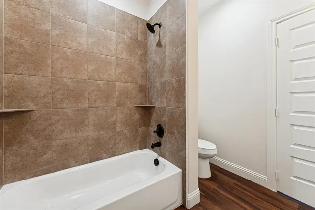 a bathroom with a bathtub and toilet