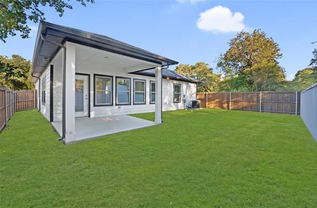 a view of a house with a yard and porch