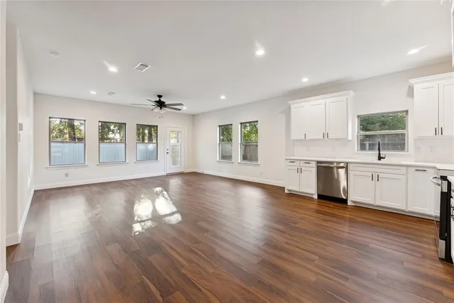 a view of kitchen with sink and wooden floor