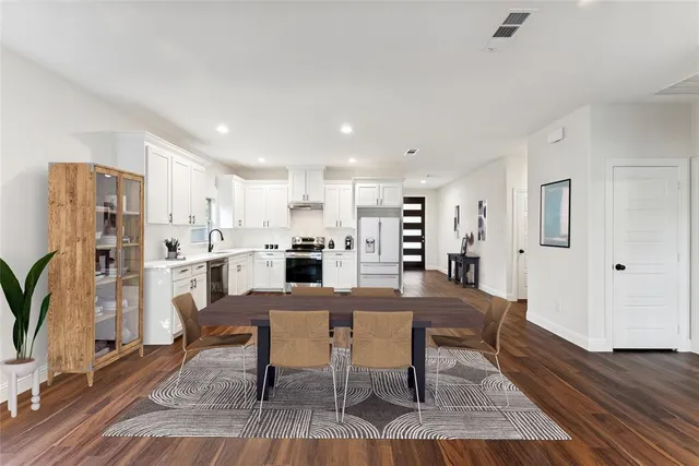 a view of a dining room with furniture and wooden floor