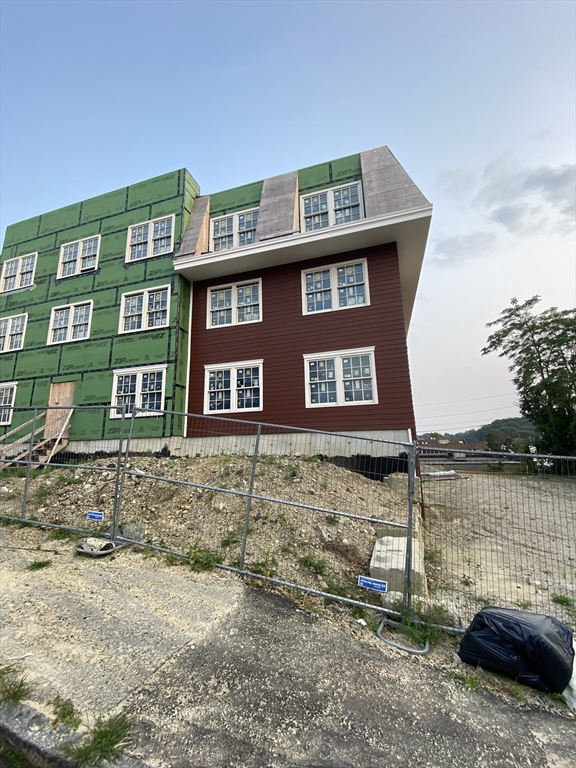 111 Austin Street Worcester, MA 01609 - Photo 3 of 4 a front view of a house with a yard