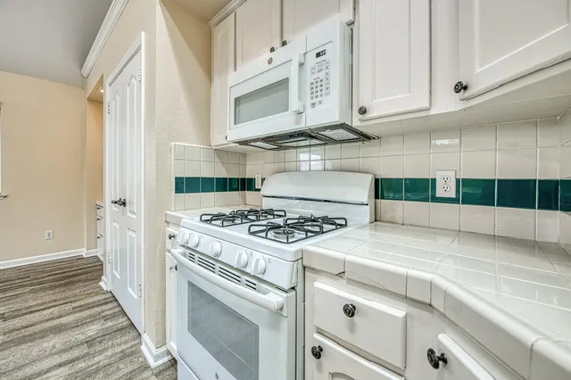 a kitchen with cabinets and appliances