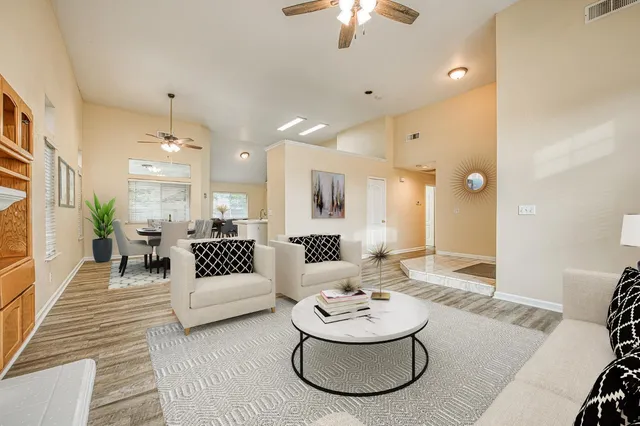 a living room with furniture and a chandelier