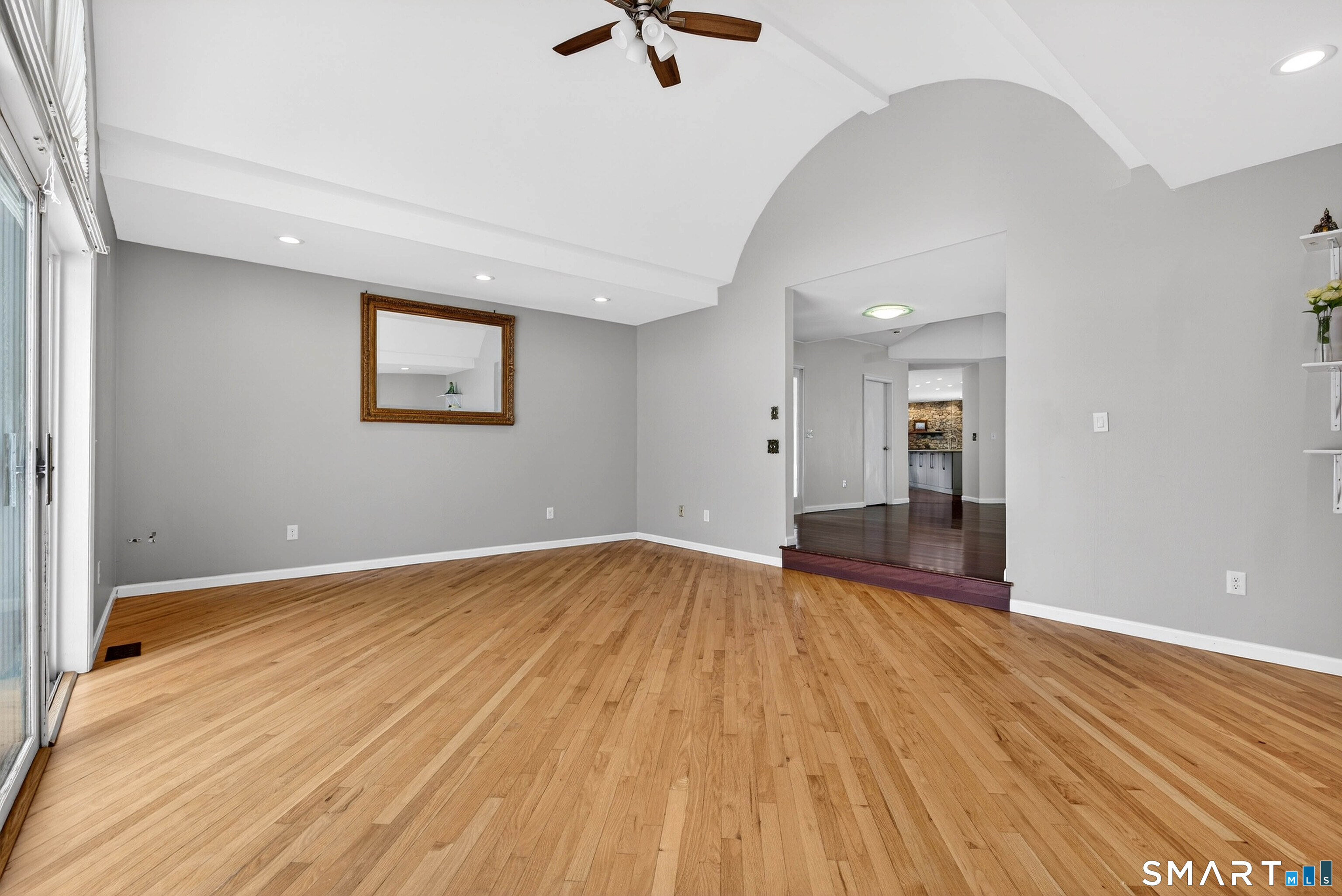 wooden floor in an empty room with a window
