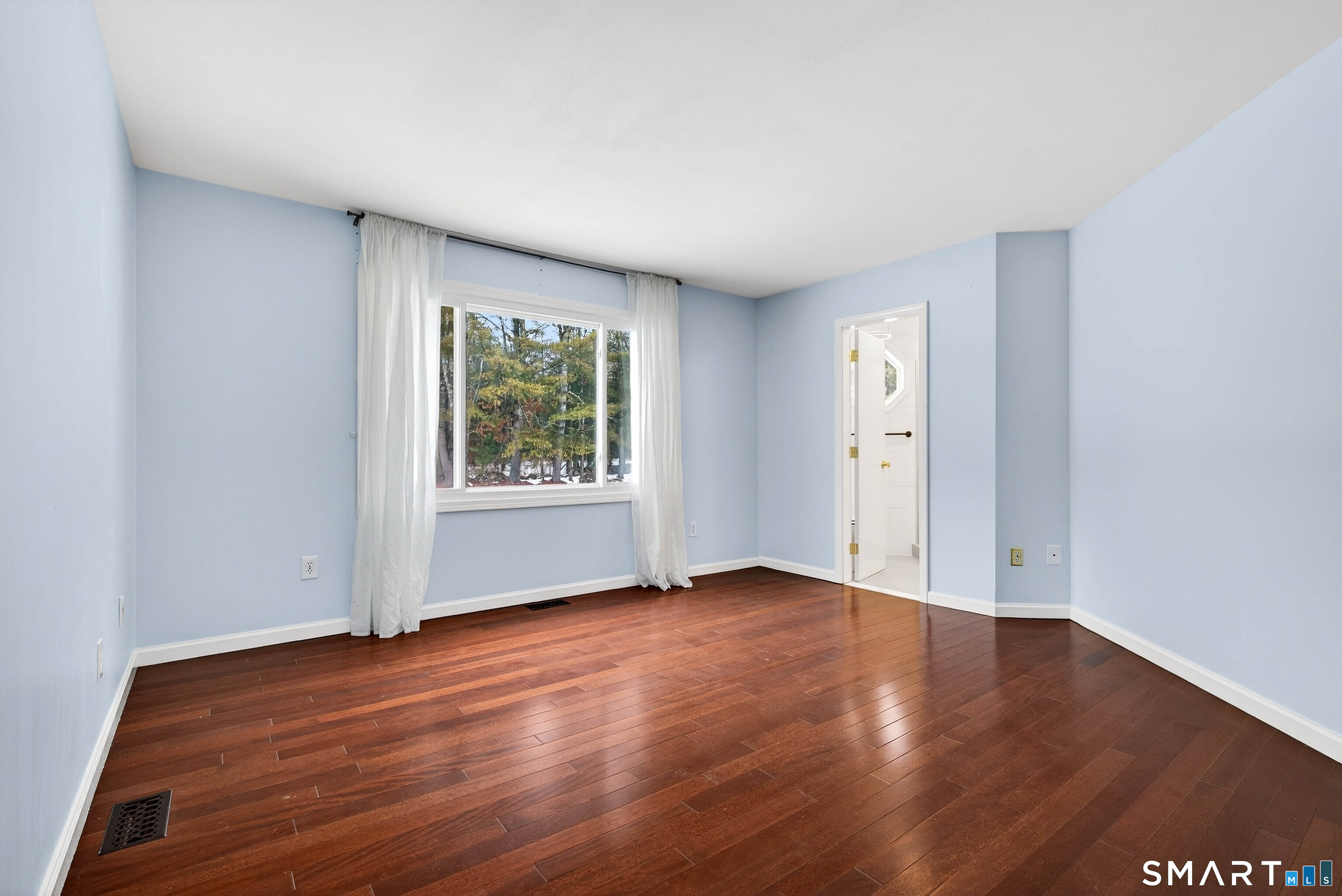 449 Lantern Hill Road Stonington, CT 06355 - Photo 11 of 40 an empty room with wooden floor and windows