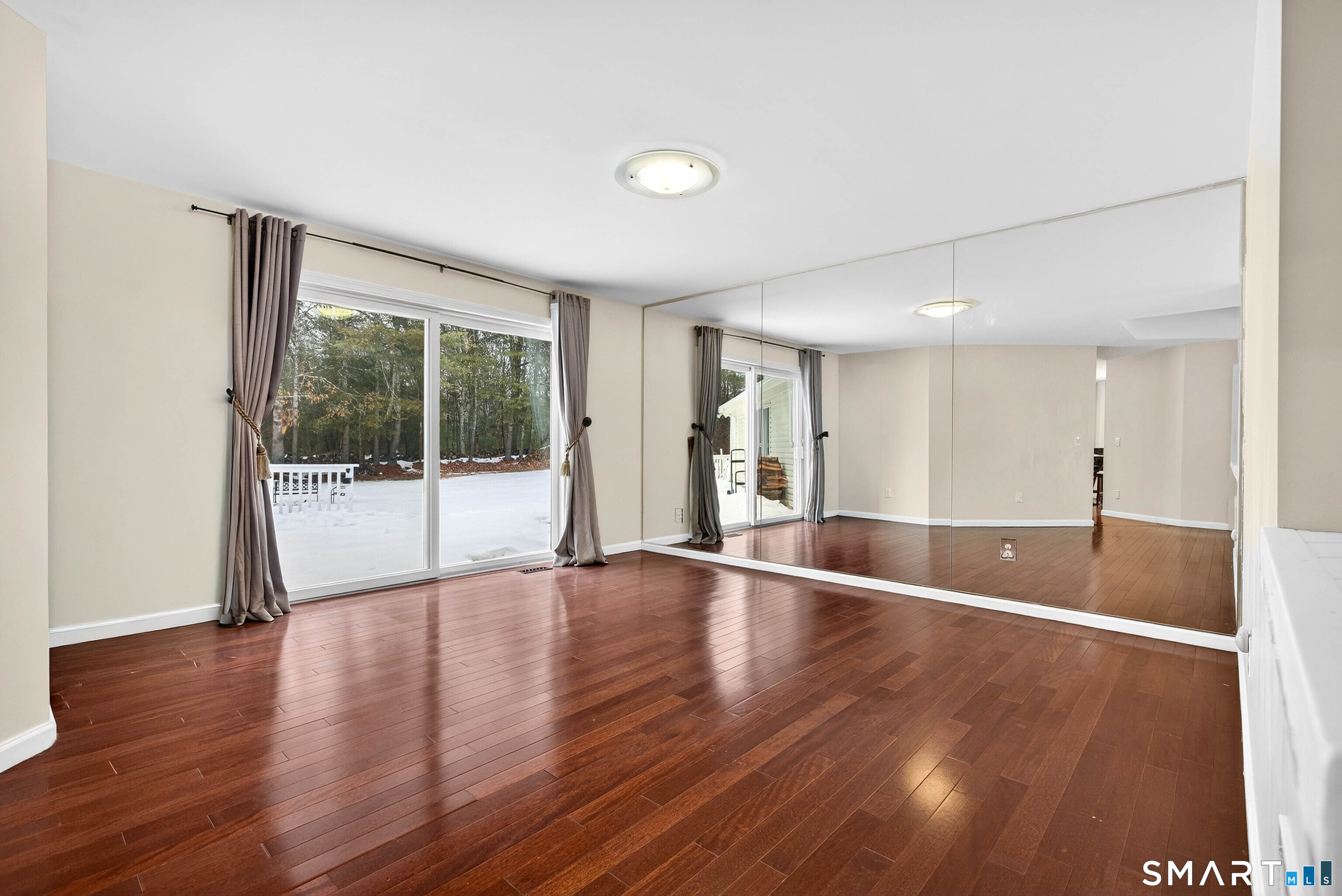 449 Lantern Hill Road Stonington, CT 06355 - Photo 14 of 40 a view of an empty room with wooden floor and a window