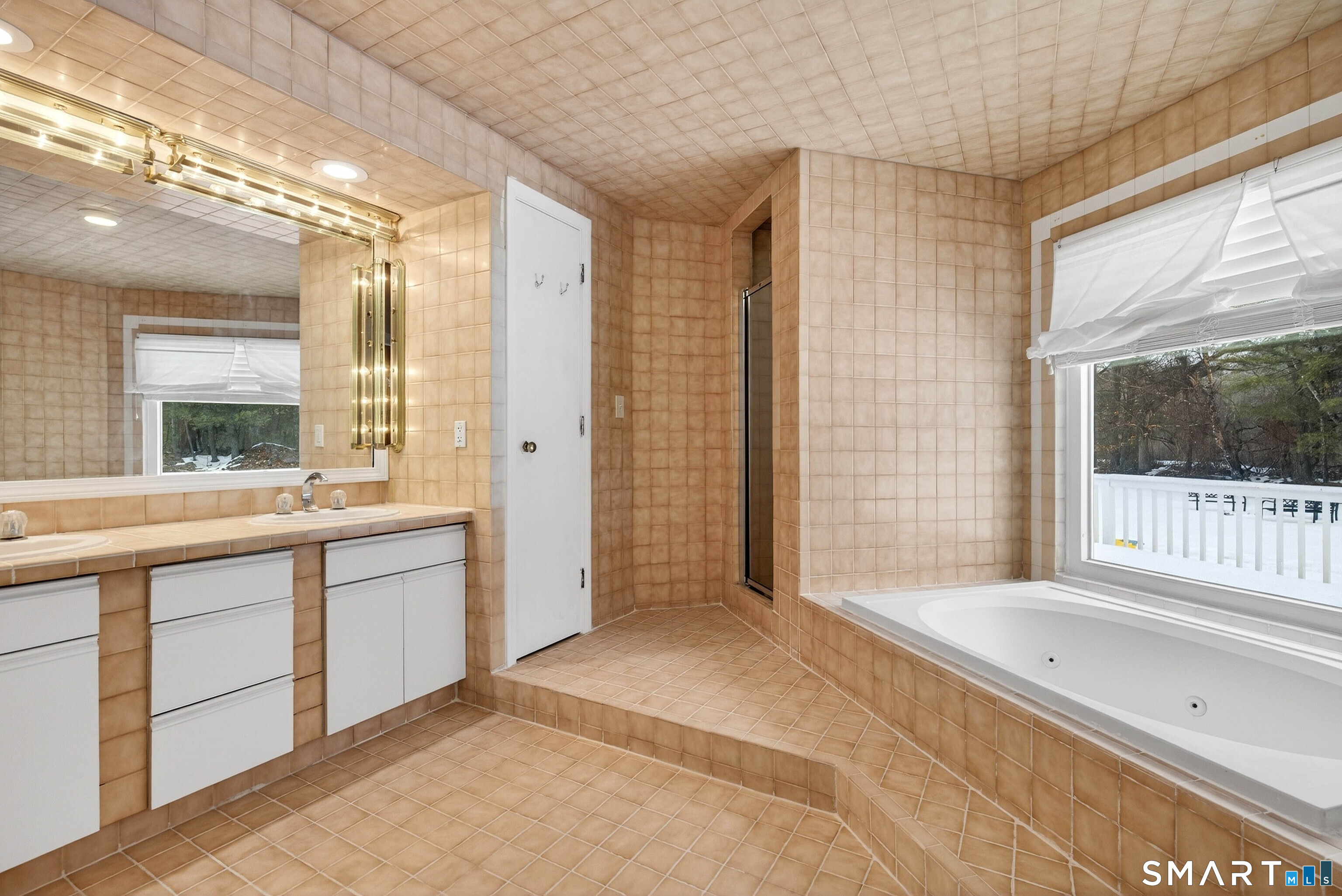 449 Lantern Hill Road Stonington, CT 06355 - Photo 19 of 40 a spacious bathroom with a large mirror vanity and shower