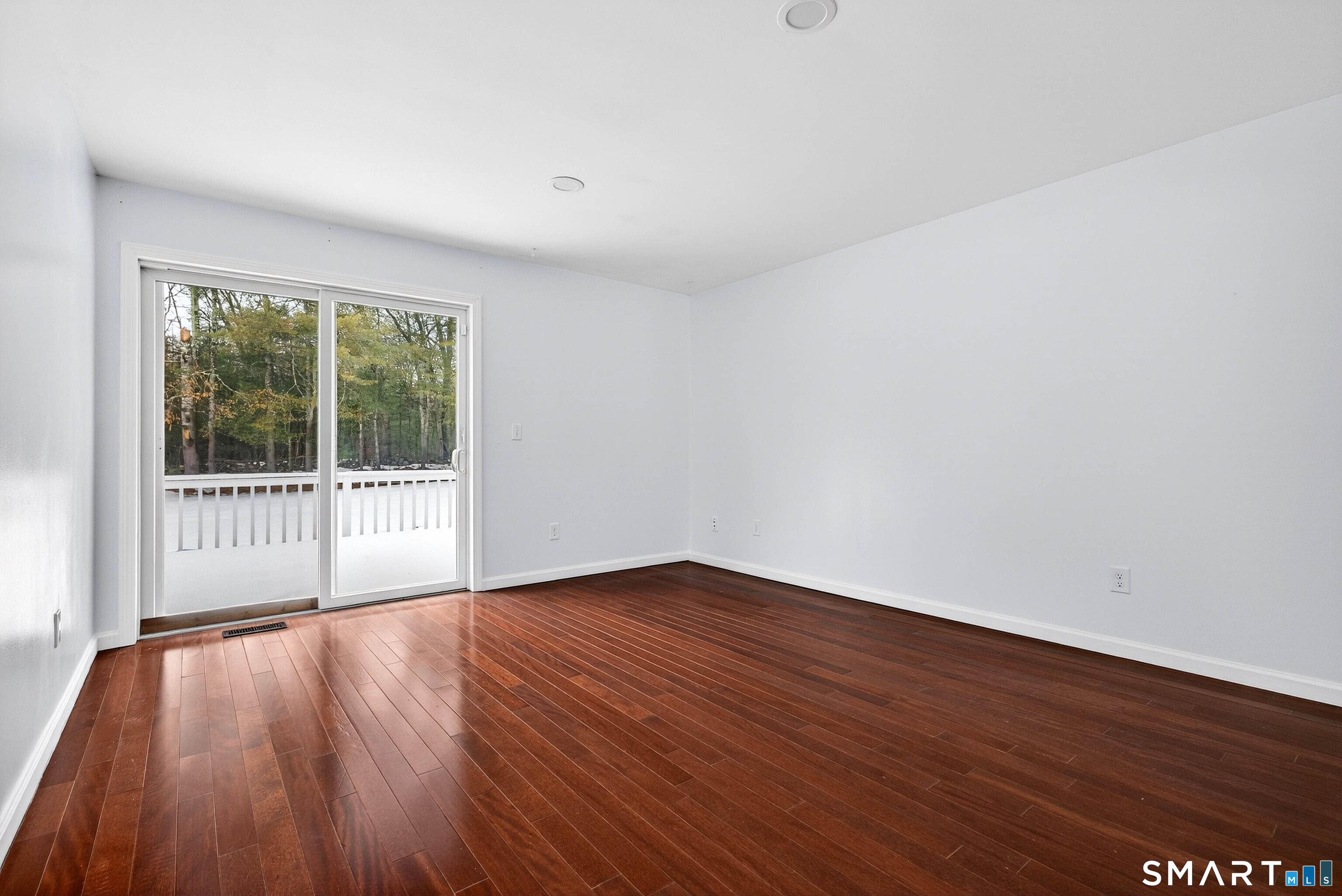 449 Lantern Hill Road Stonington, CT 06355 - Photo 22 of 40 a view of an empty room with wooden floor and a window
