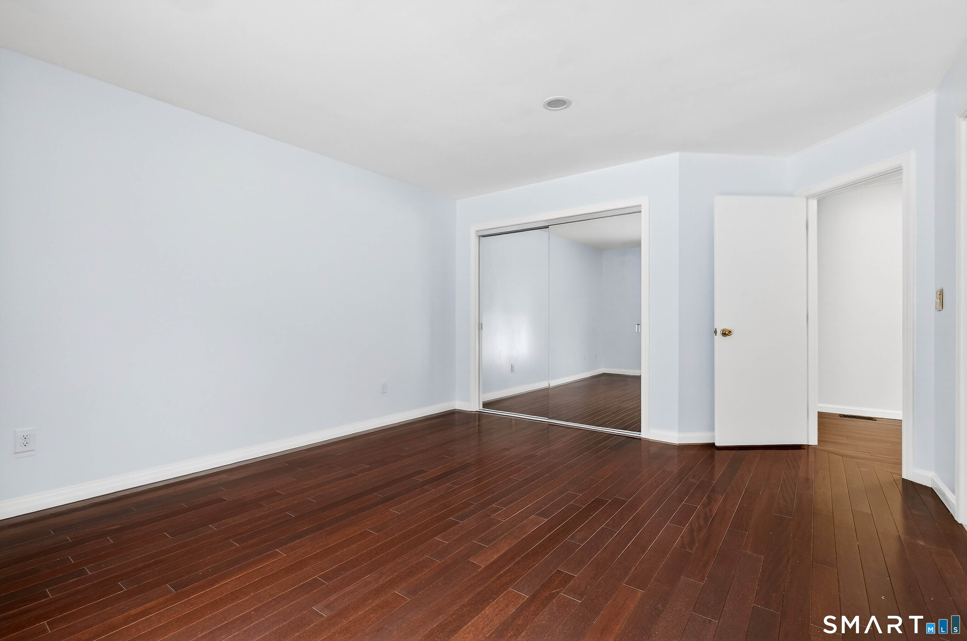 449 Lantern Hill Road Stonington, CT 06355 - Photo 23 of 40 an empty room with wooden floor and closet