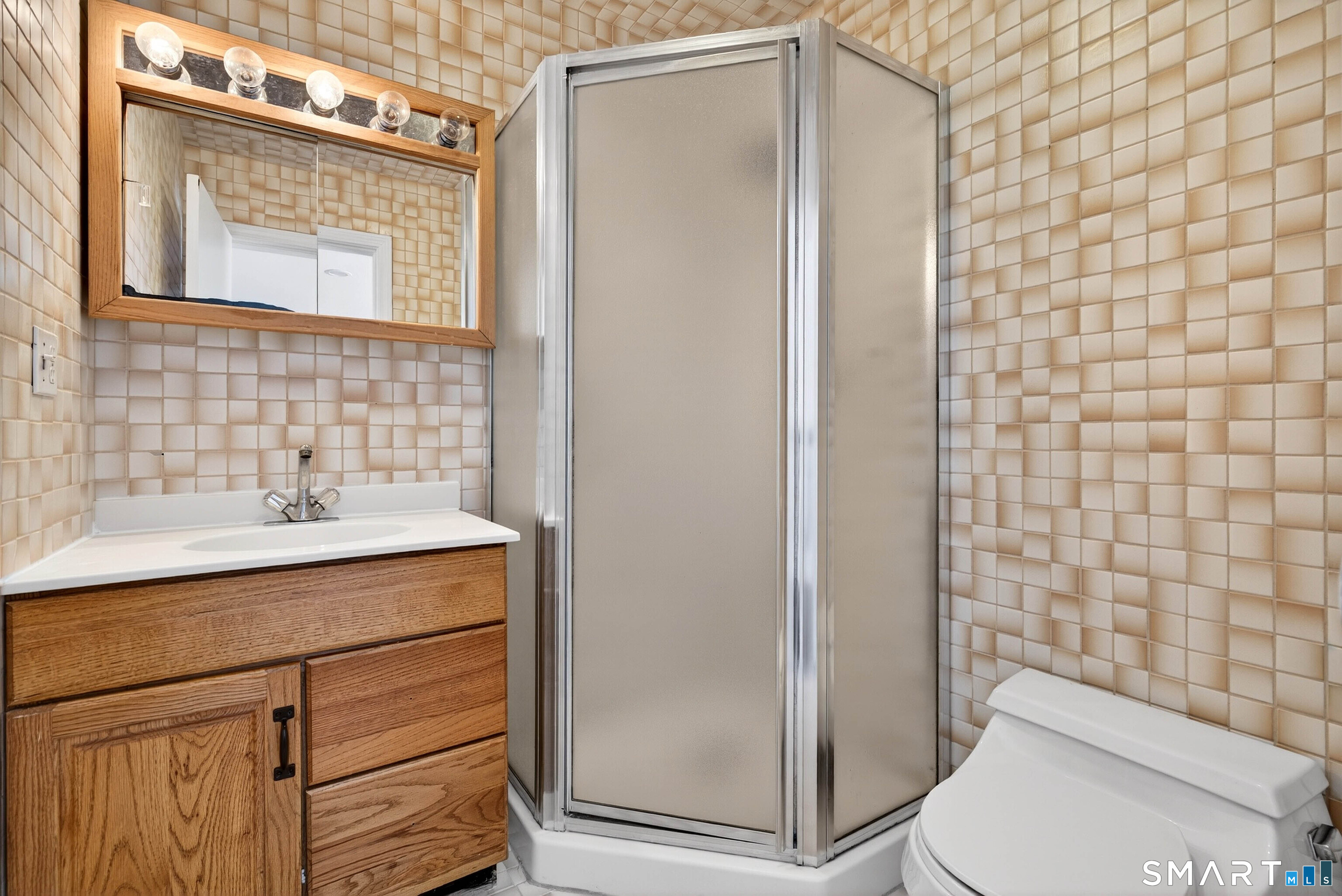 449 Lantern Hill Road Stonington, CT 06355 - Photo 25 of 40 a bathroom with a sink a toilet and shower