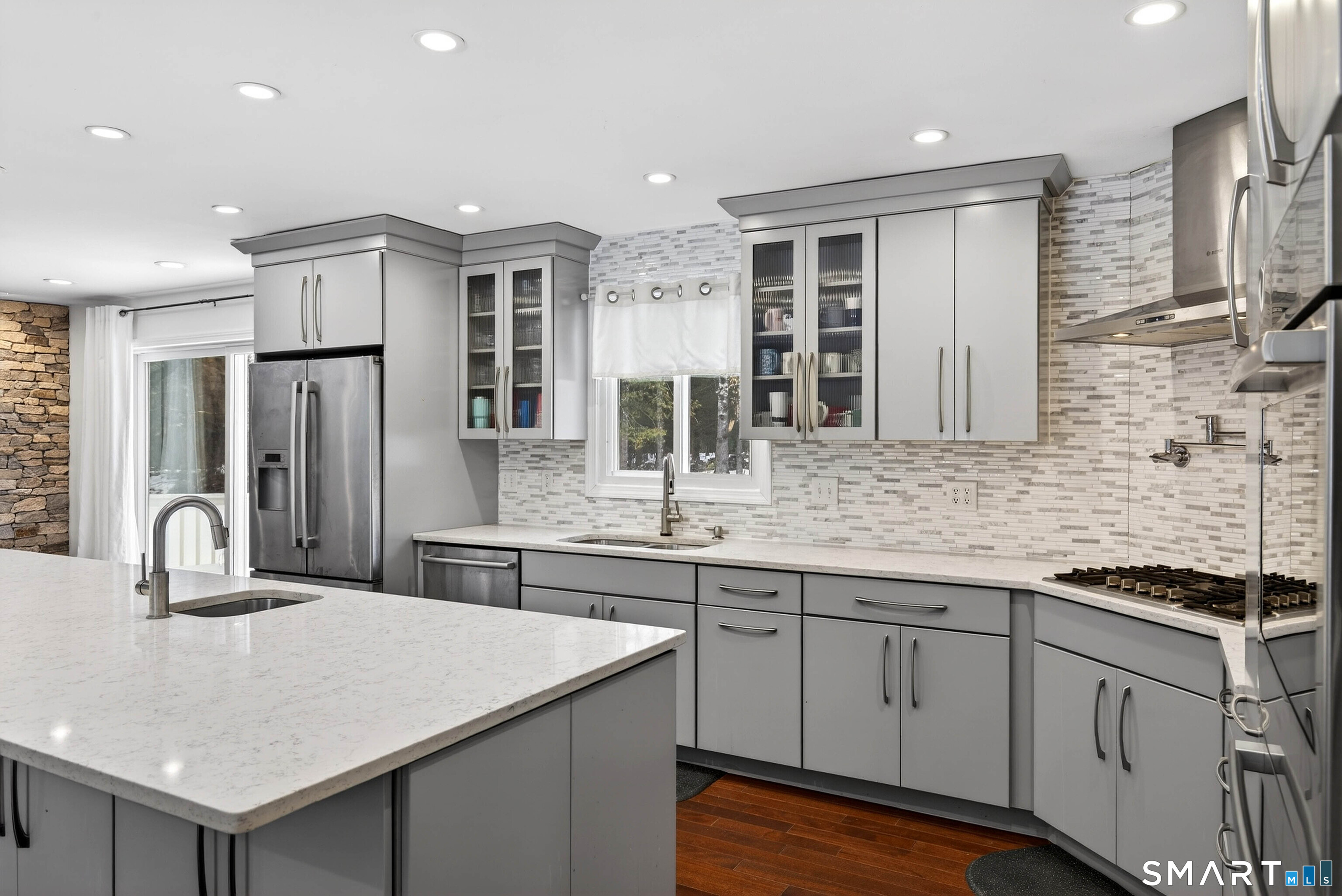 449 Lantern Hill Road Stonington, CT 06355 - Photo 27 of 40 a kitchen with stainless steel appliances granite countertop a sink and cabinets