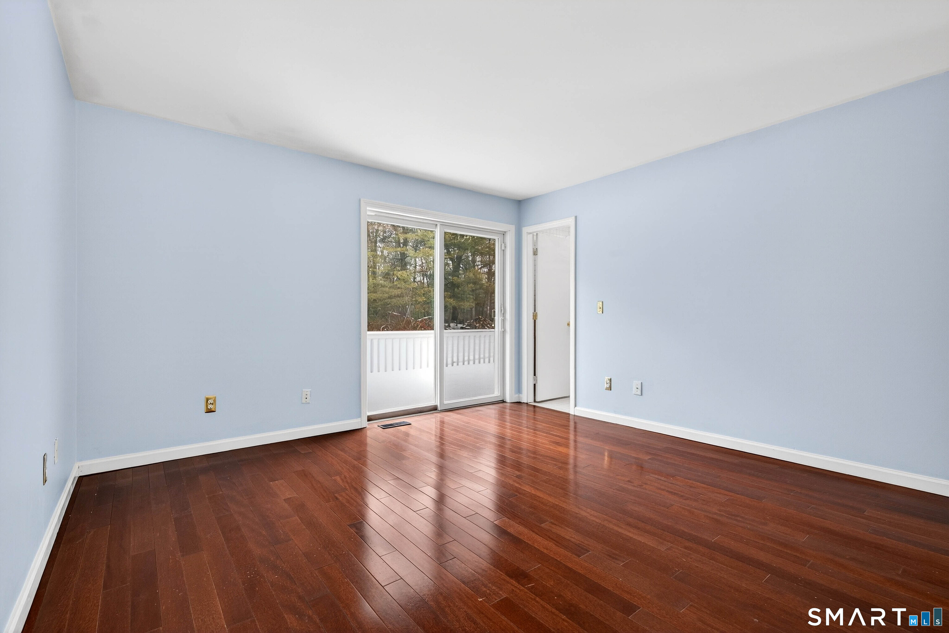 449 Lantern Hill Road Stonington, CT 06355 - Photo 3 of 40 a view of an empty room with wooden floor and a window