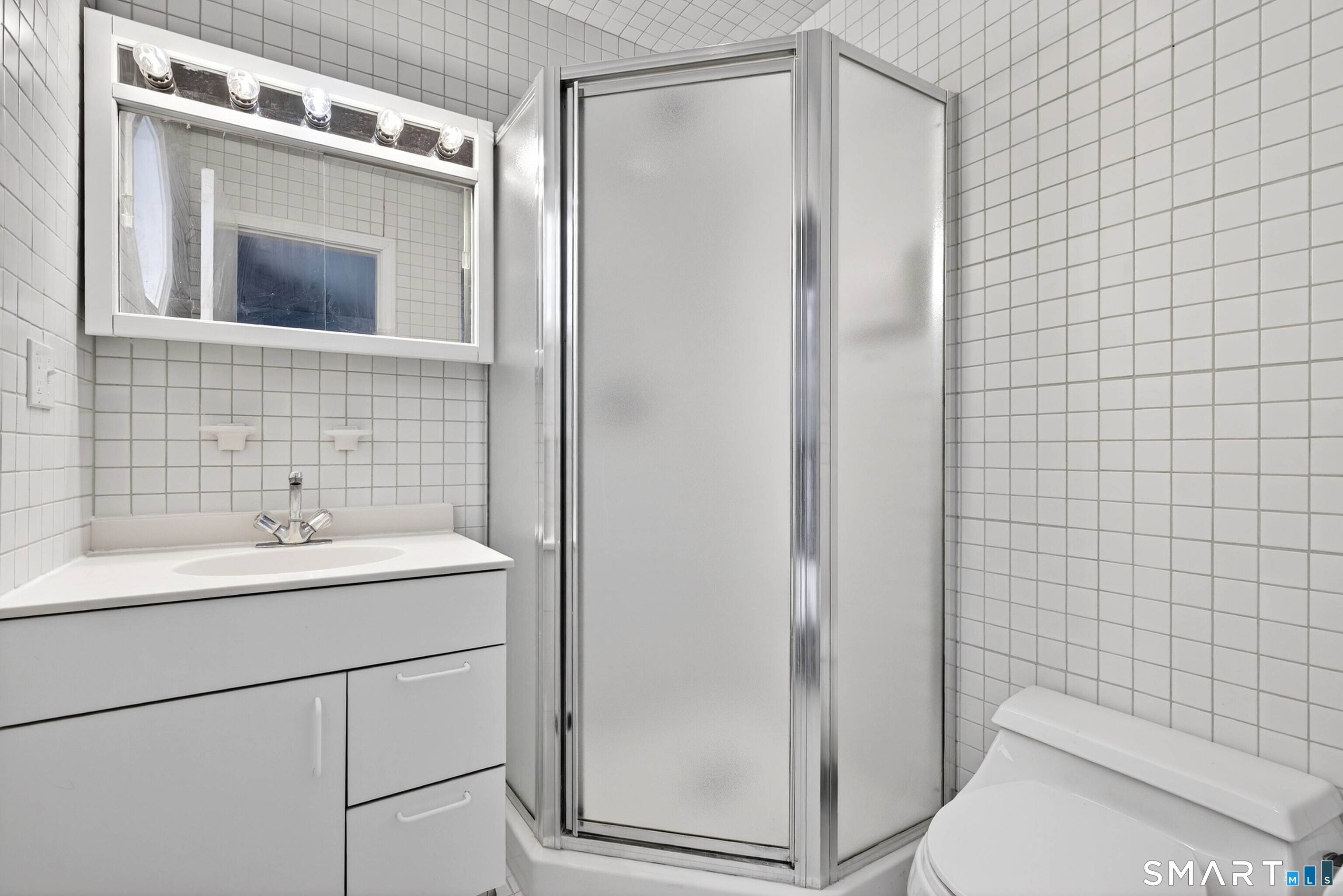 449 Lantern Hill Road Stonington, CT 06355 - Photo 4 of 40 a bathroom with a sink a toilet and shower