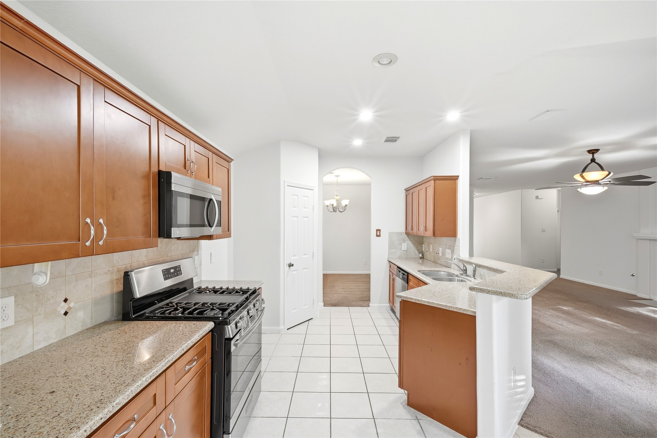5411 Gate Canyon Court Spring, TX 77373 - Photo 14 of 33 a kitchen with stainless steel appliances granite countertop a sink stove and refrigerator