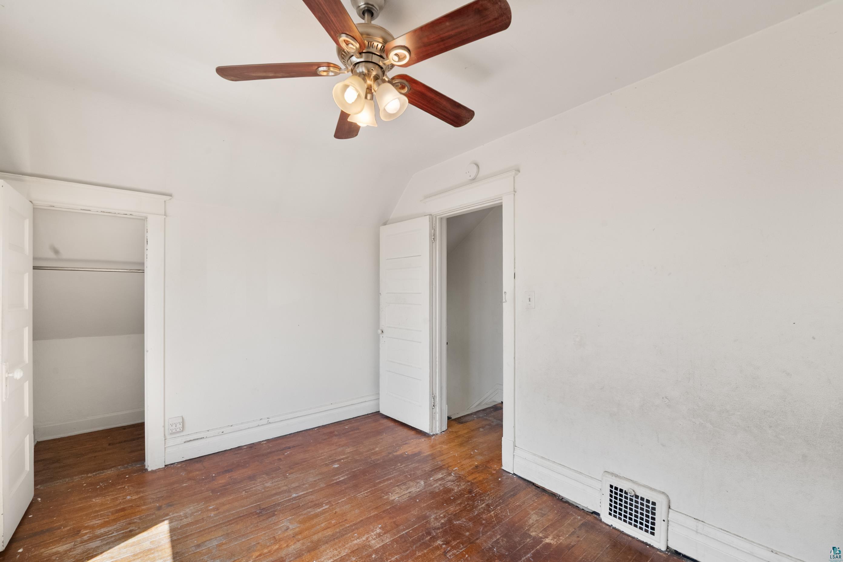 3067 Restormel Street Duluth, MN 55806 - Photo 10 of 25 Room featuring wood-finish flooring, white walls, and a ceiling fan with integrated lighting