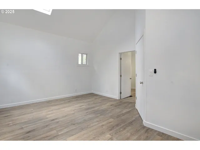 a view of an empty room and wooden floor
