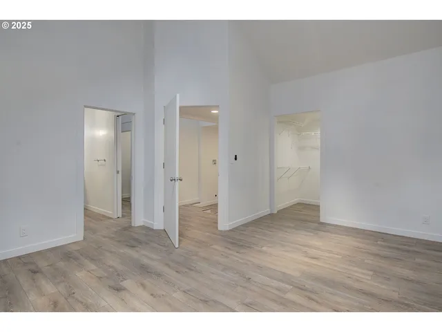 a view of an empty room and wooden floor