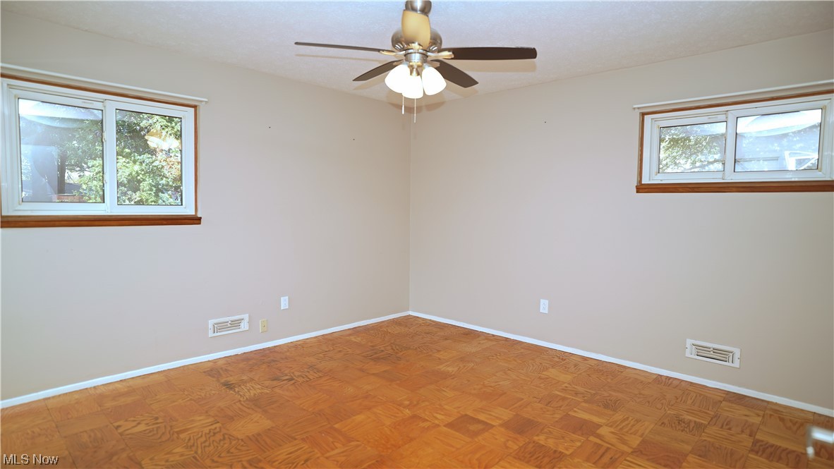 6676 Rochelle Boulevard Parma Heights, OH 44130 - Photo 11 of 21 Spare room with ceiling fan and parquet flooring