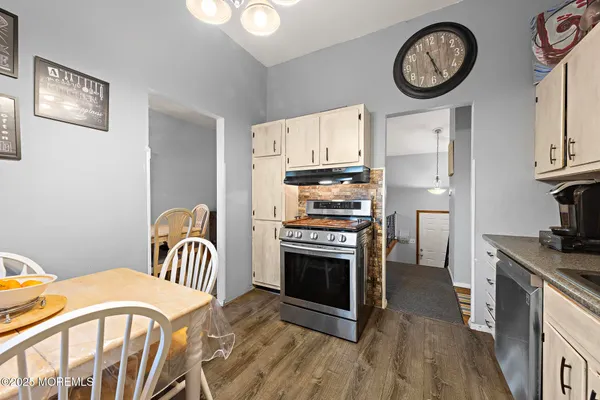 a kitchen with stainless steel appliances a stove a table and a refrigerator