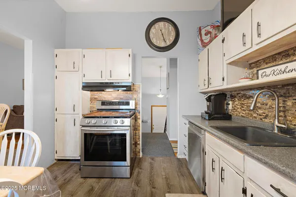 a kitchen with stainless steel appliances granite countertop a stove and a refrigerator