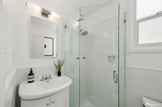 a bathroom with a sink a mirror and shower