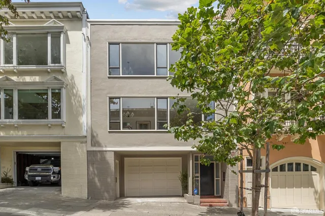 a view of a house with a tree