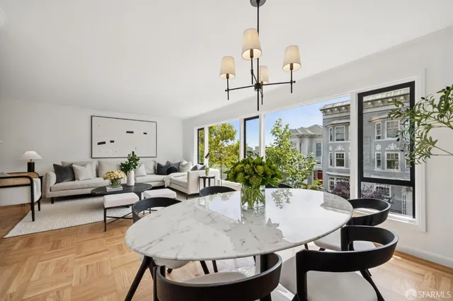a living room with furniture and a chandelier