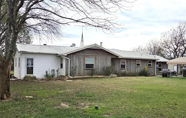 a front view of house with yard and trees