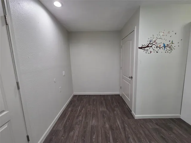 a view of a room with wooden floor