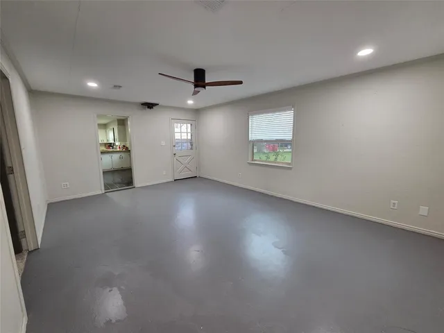a kitchen with cabinets appliances and a ceiling fan