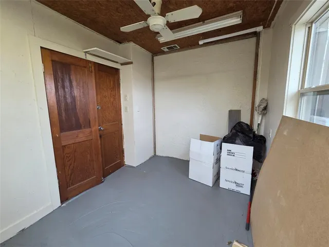 a view of room with a ceiling fan and window
