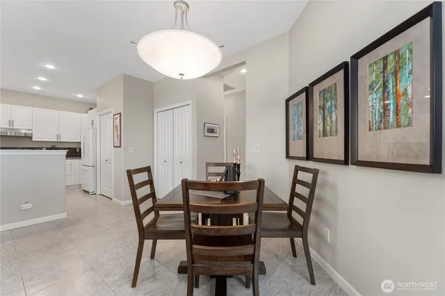 a view of a dining room with furniture and a large window