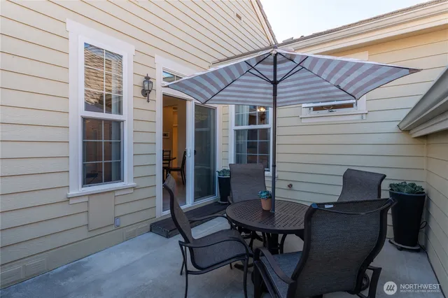 a balcony with table and chairs