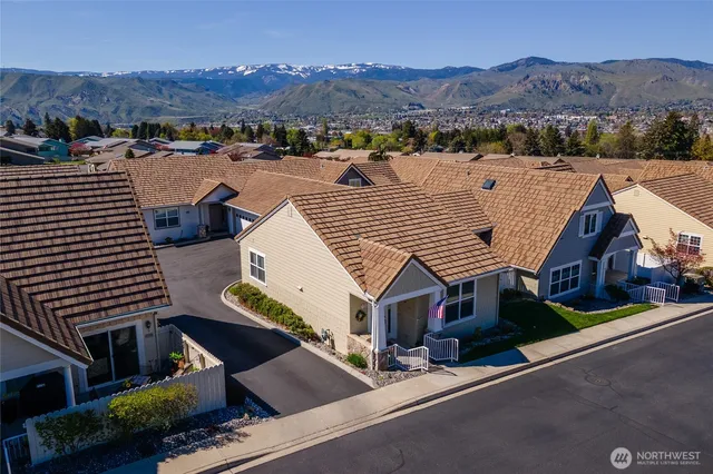 an aerial view of houses with a street