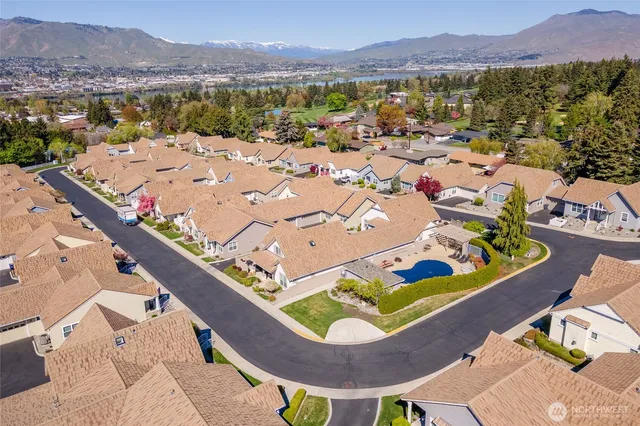 an aerial view of residential houses with outdoor space and river