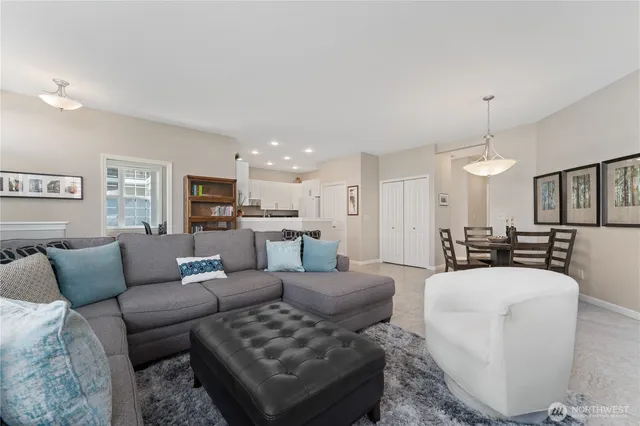 a living room with furniture and a view of kitchen