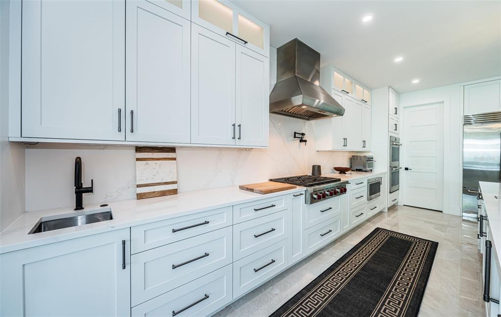218 Sydney Lane Redington Shores, FL 33708 - Photo 32 of 100 a kitchen with stainless steel appliances granite countertop a sink stove and refrigerator