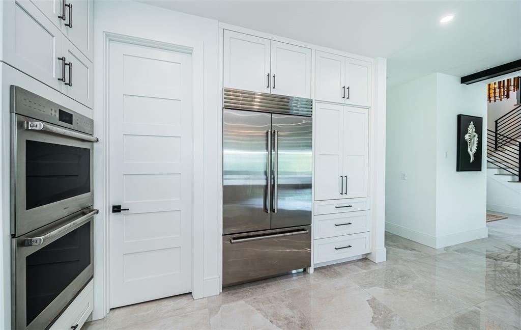 218 Sydney Lane Redington Shores, FL 33708 - Photo 34 of 100 a kitchen with cabinets and steel stainless steel appliances