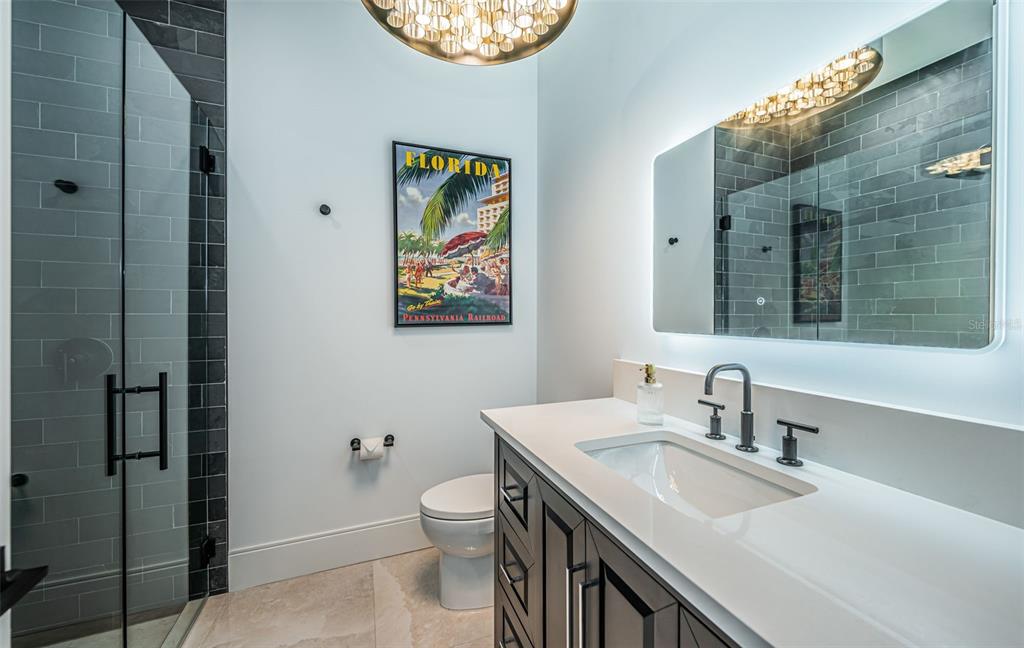 218 Sydney Lane Redington Shores, FL 33708 - Photo 41 of 100 a bathroom with a sink a toilet and a mirror
