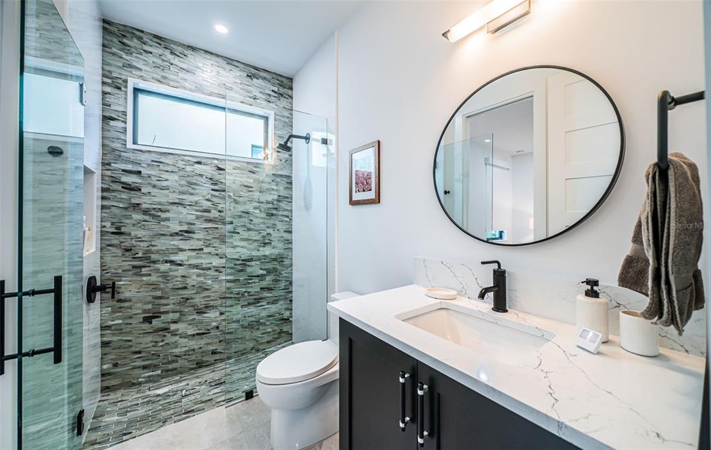 218 Sydney Lane Redington Shores, FL 33708 - Photo 47 of 100 a bathroom with a sink a toilet and a mirror