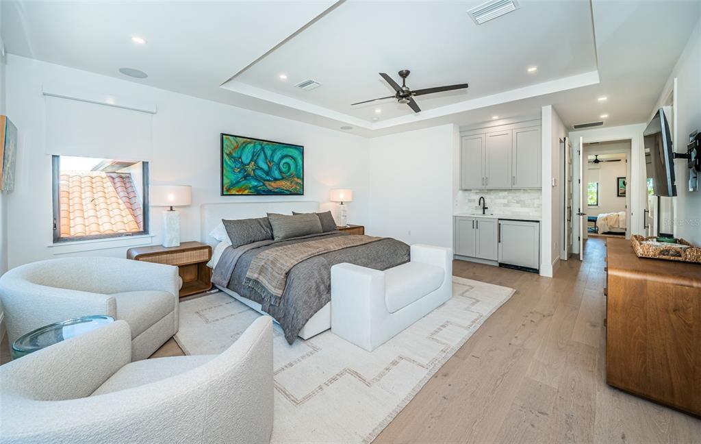 218 Sydney Lane Redington Shores, FL 33708 - Photo 55 of 100 a spacious bedroom with a bed a couch and a window