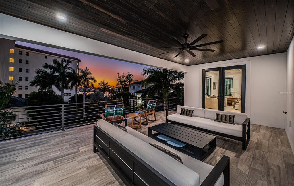 218 Sydney Lane Redington Shores, FL 33708 - Photo 61 of 100 a outdoor space with wooden floor and outdoor seating