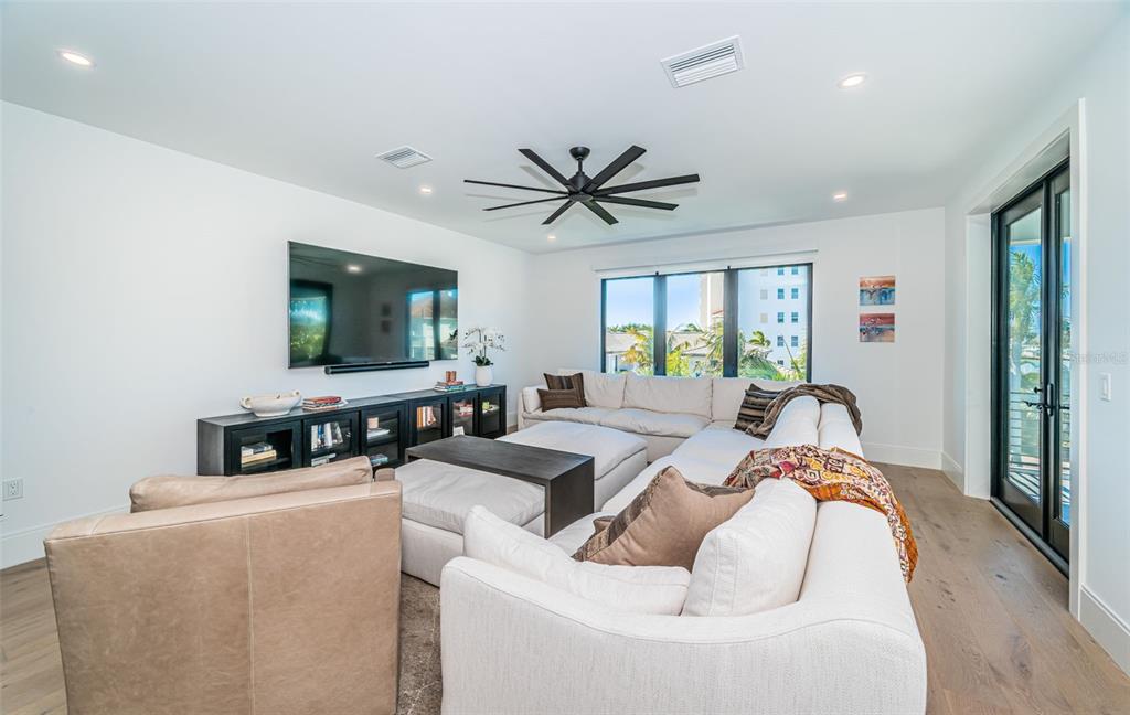 218 Sydney Lane Redington Shores, FL 33708 - Photo 70 of 100 a living room with furniture and a flat screen tv