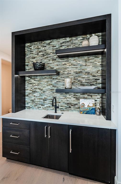 218 Sydney Lane Redington Shores, FL 33708 - Photo 72 of 100 a kitchen with a sink and cabinets