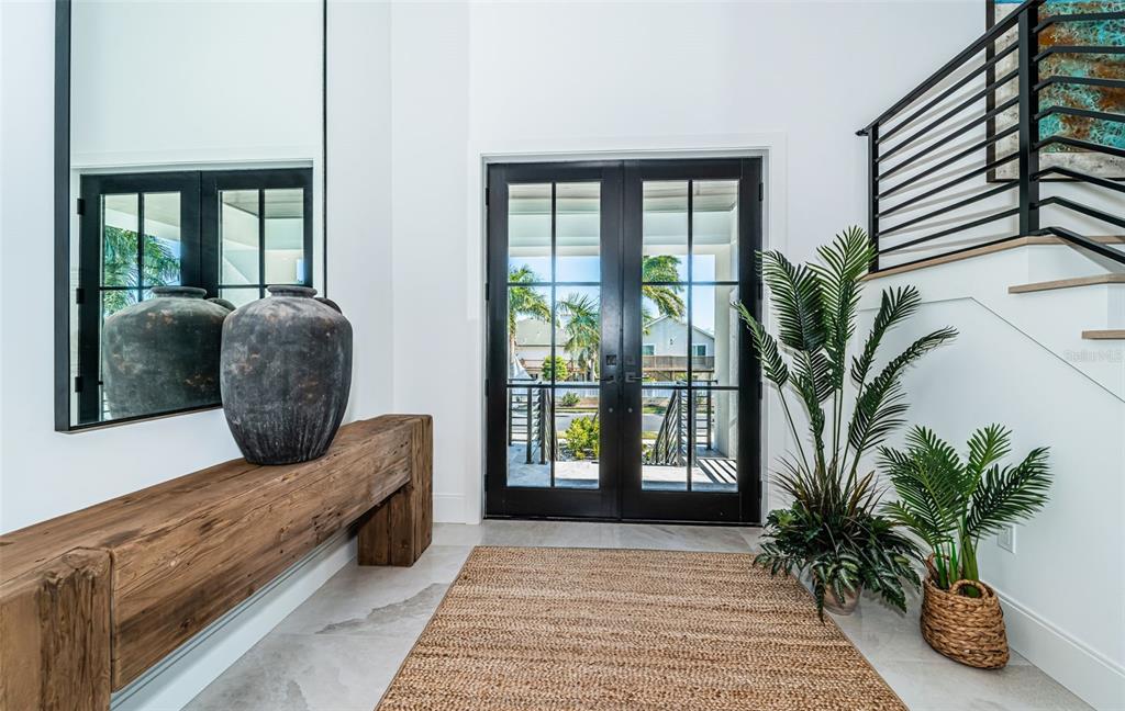 218 Sydney Lane Redington Shores, FL 33708 - Photo 9 of 100 a view of entryway with wooden floor and a potted plant