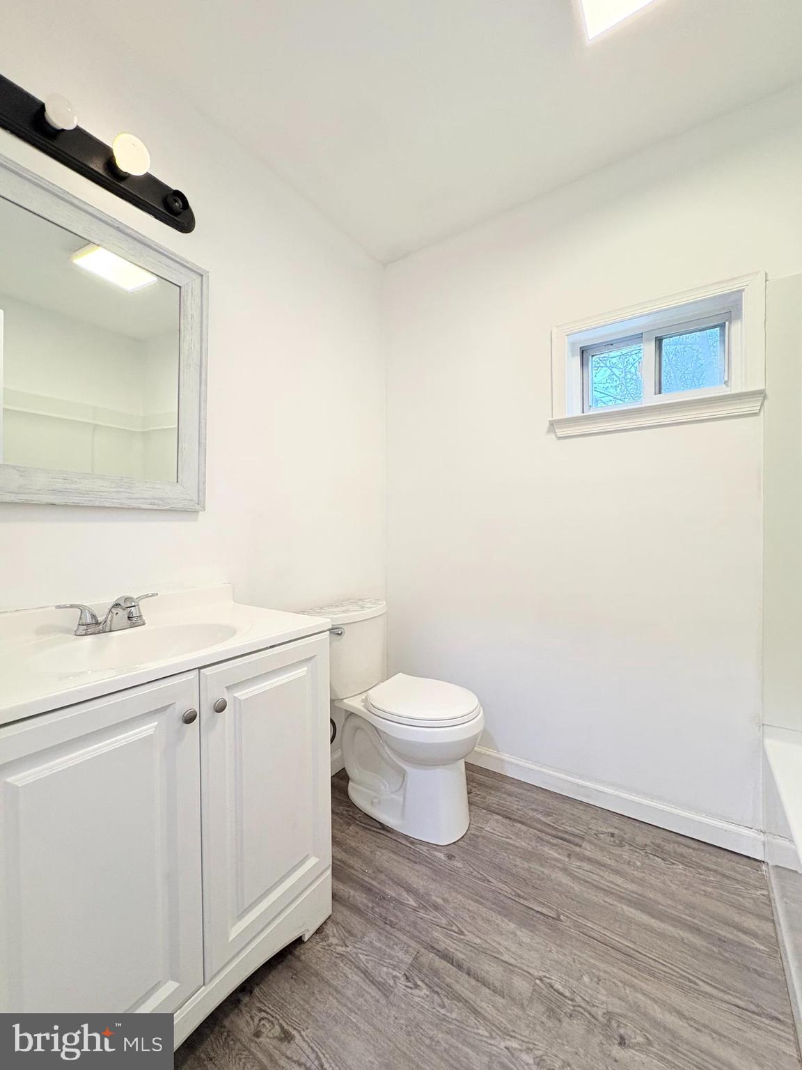 1630 East 9th Street Bethlehem, PA 18015 - Photo 11 of 17 a bathroom with a toilet a sink a vanity and mirror