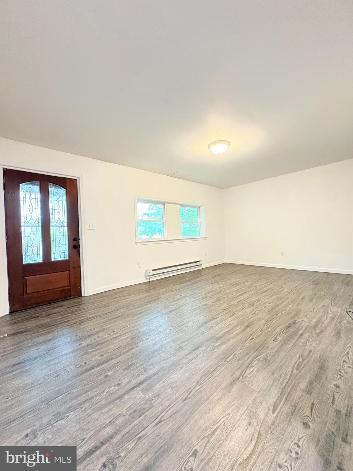 1630 East 9th Street Bethlehem, PA 18015 - Photo 2 of 17 an empty room with wooden floor and windows