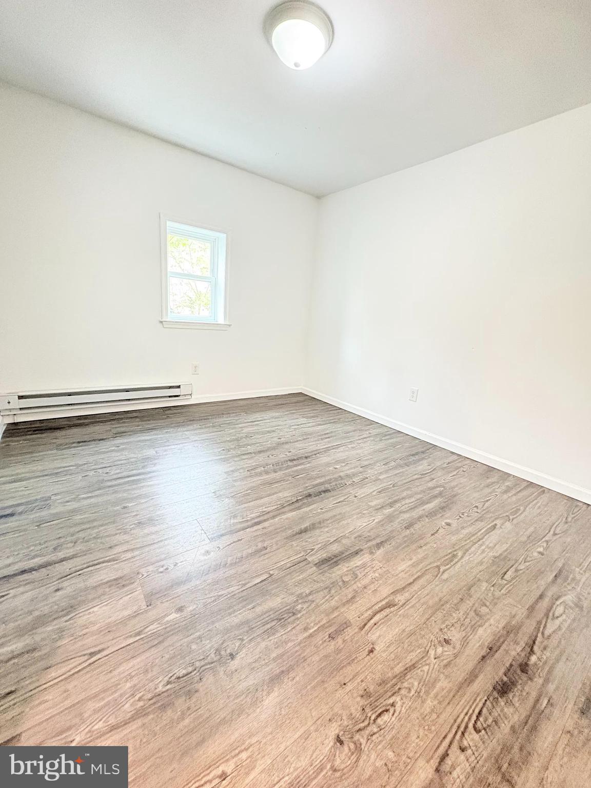 1630 East 9th Street Bethlehem, PA 18015 - Photo 6 of 17 a view of an empty room with wooden floor and a window